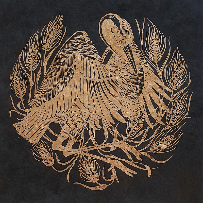 Block print of a golden crane and wheat stalks on black paper