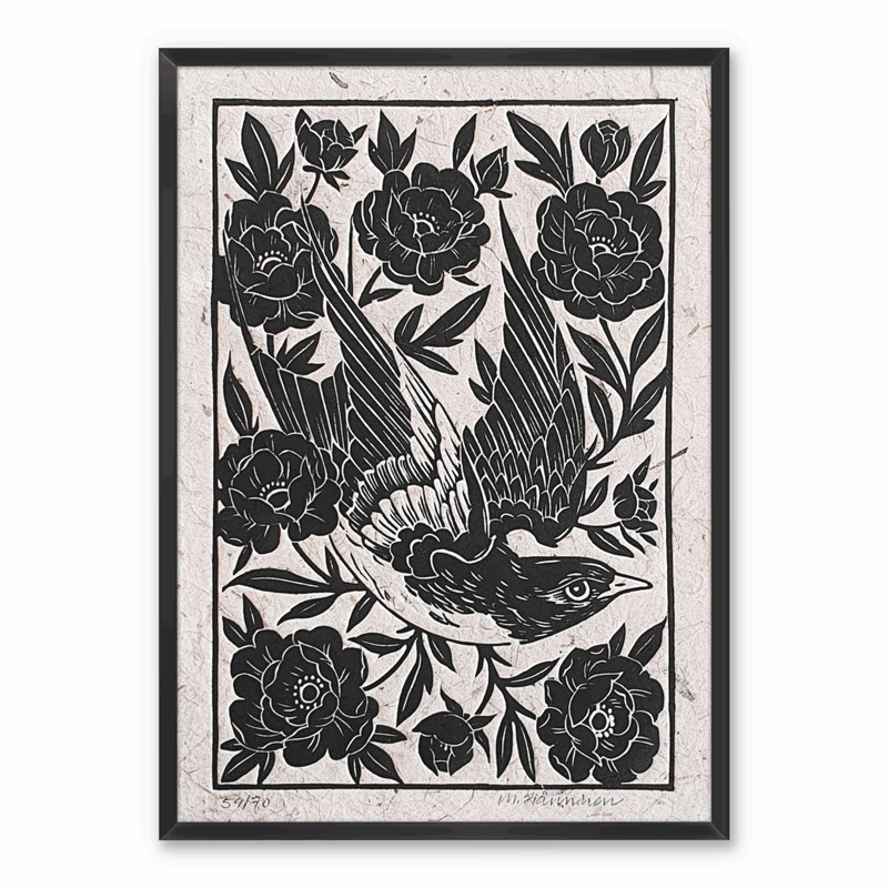 A framed linocut print of a swallow flying through flowers