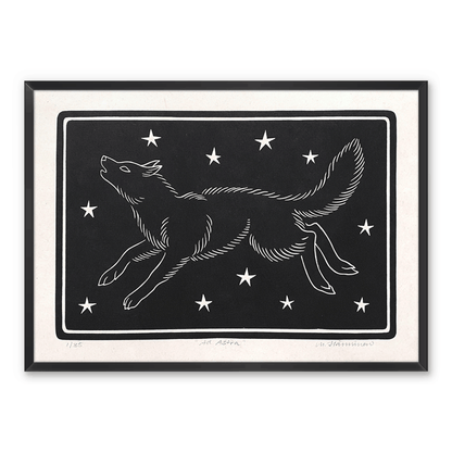 Handmade art print of a howling wolf running across starry sky, framed on a wall