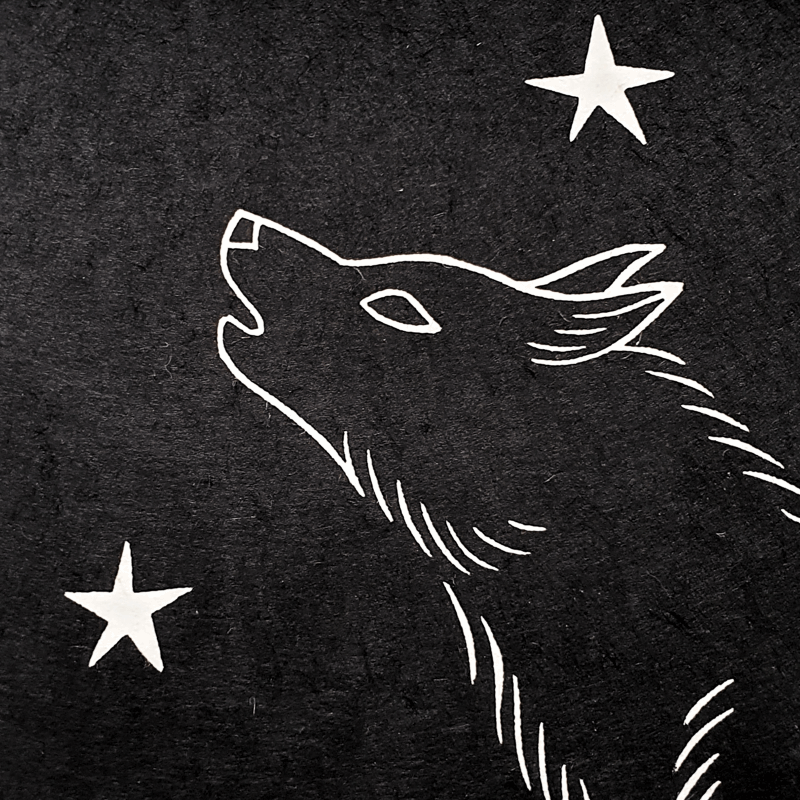 Detail of a linocut wolf and stars