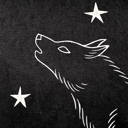 Detail of a linocut wolf and stars