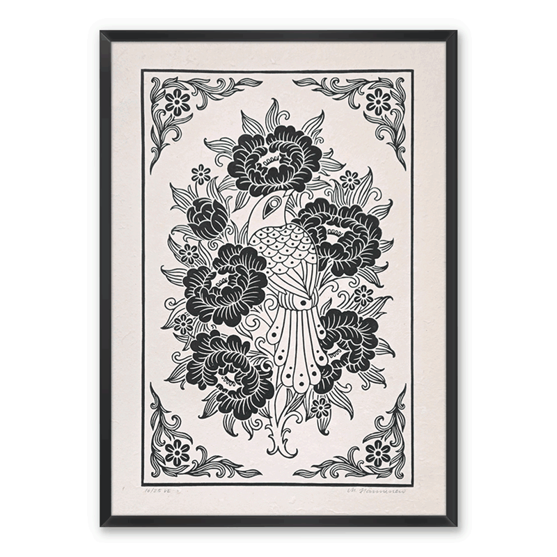 Framed bird linocut print on a white wall