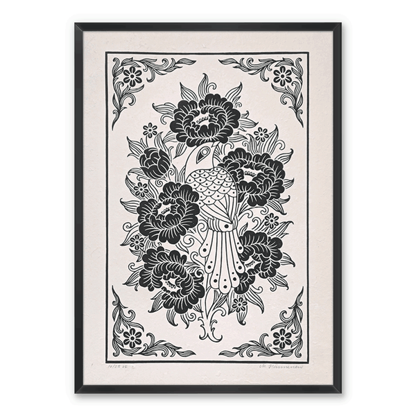 Framed bird linocut print on a white wall