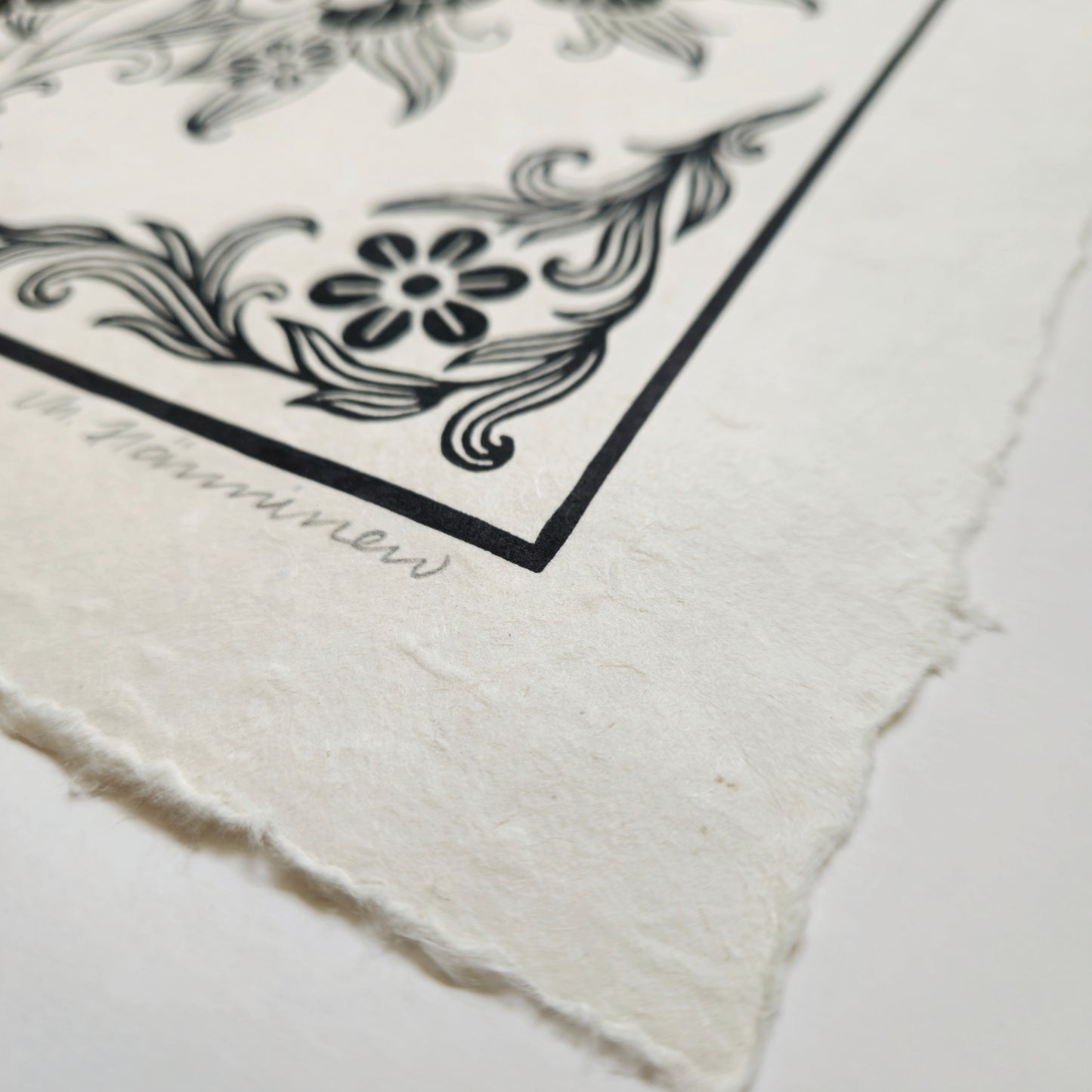 Detail of a linocut print deckle edge and handmade paper