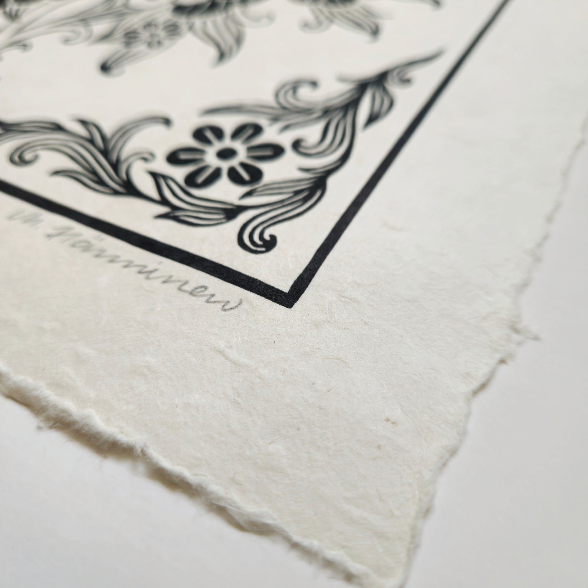 Detail of a linocut print deckle edge and handmade paper