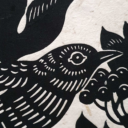 Closeup of a bird linocut print on textured paper