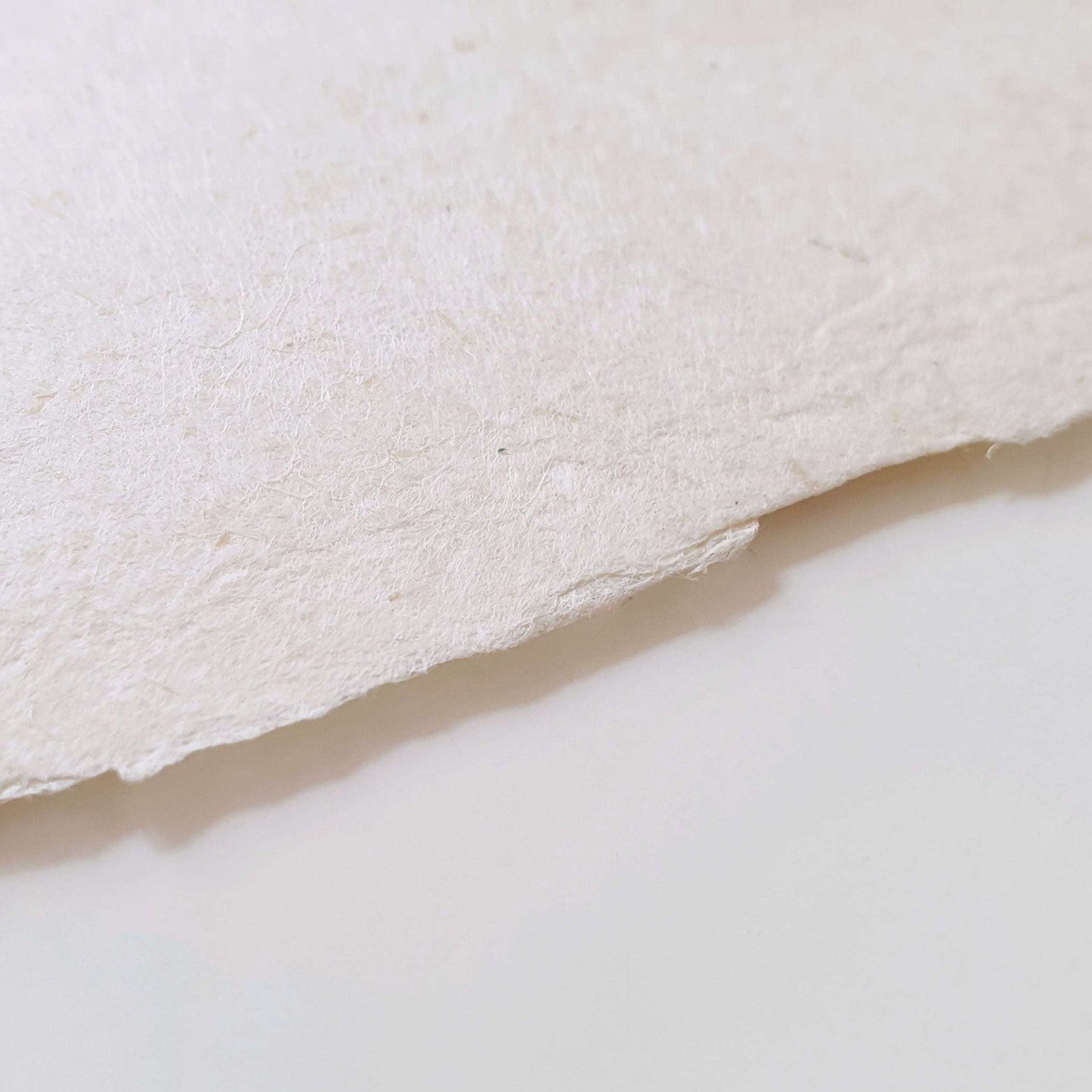Closeup shot of white handmade paper with deckle edge