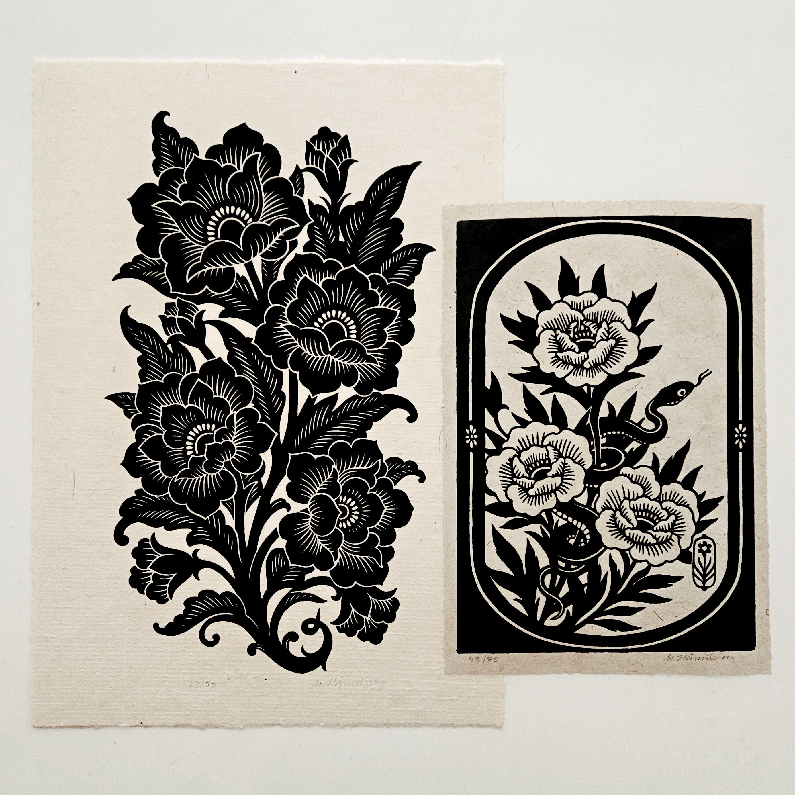 Two relief prints on a white table