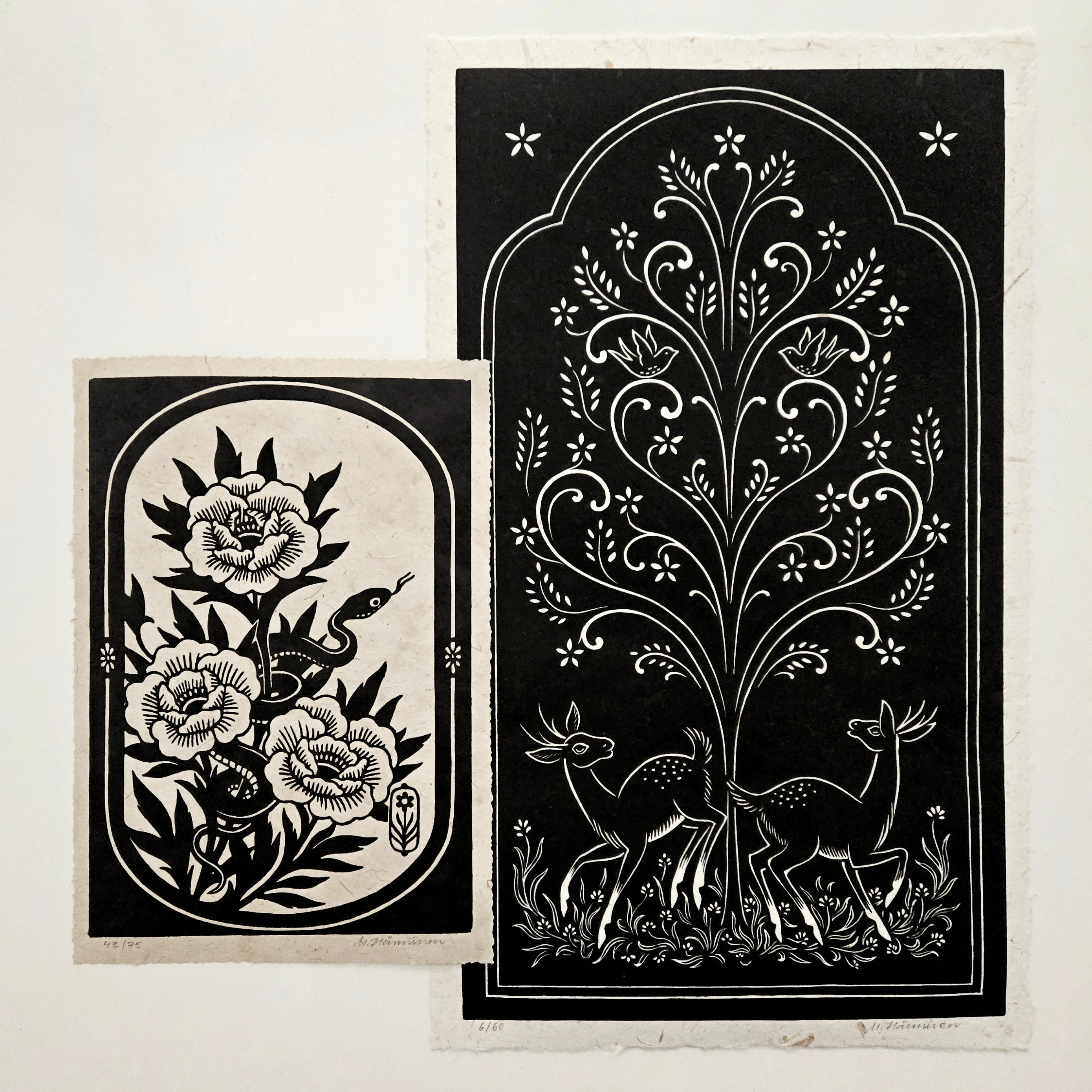 Two relief prints on a white table
