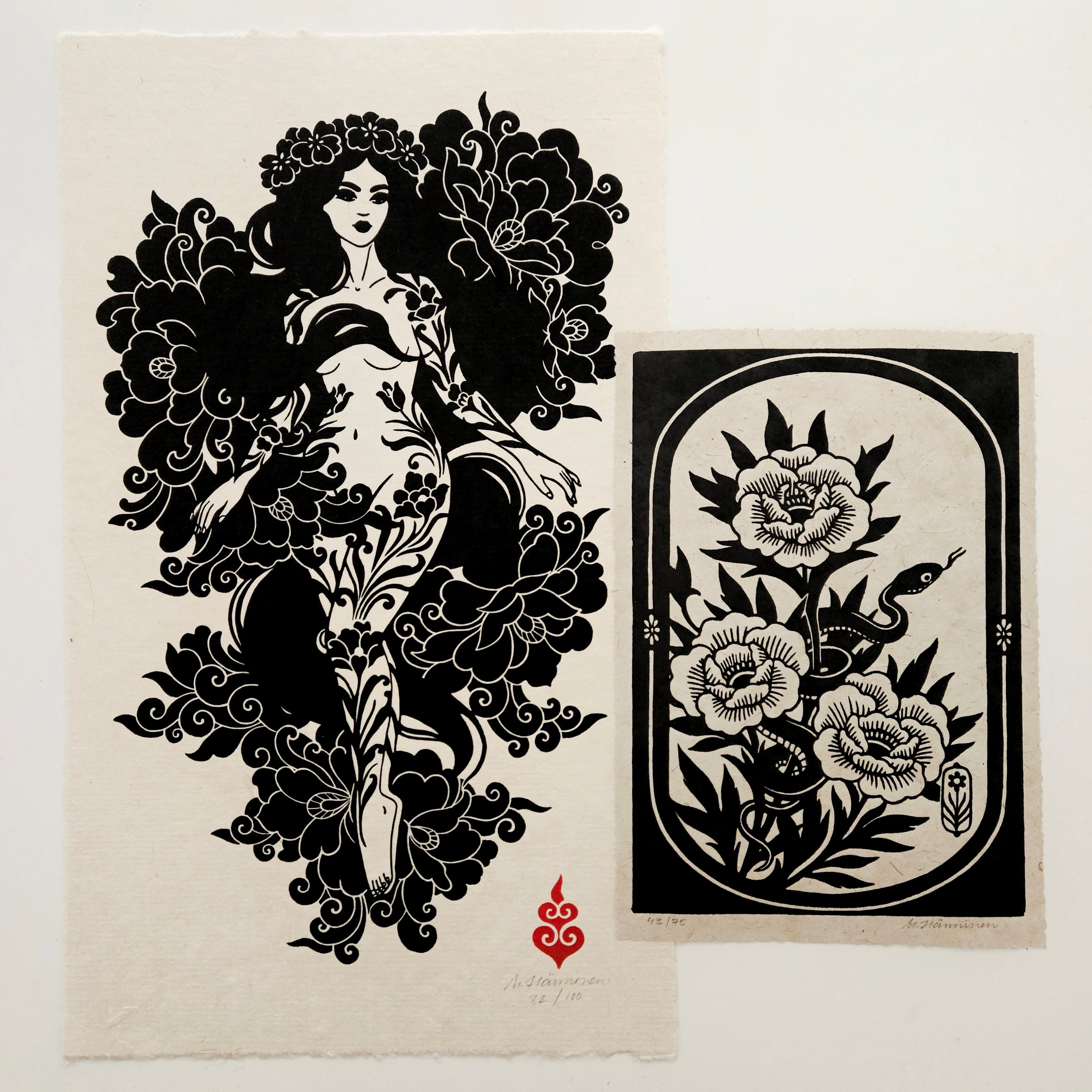 Two relief prints on a white table