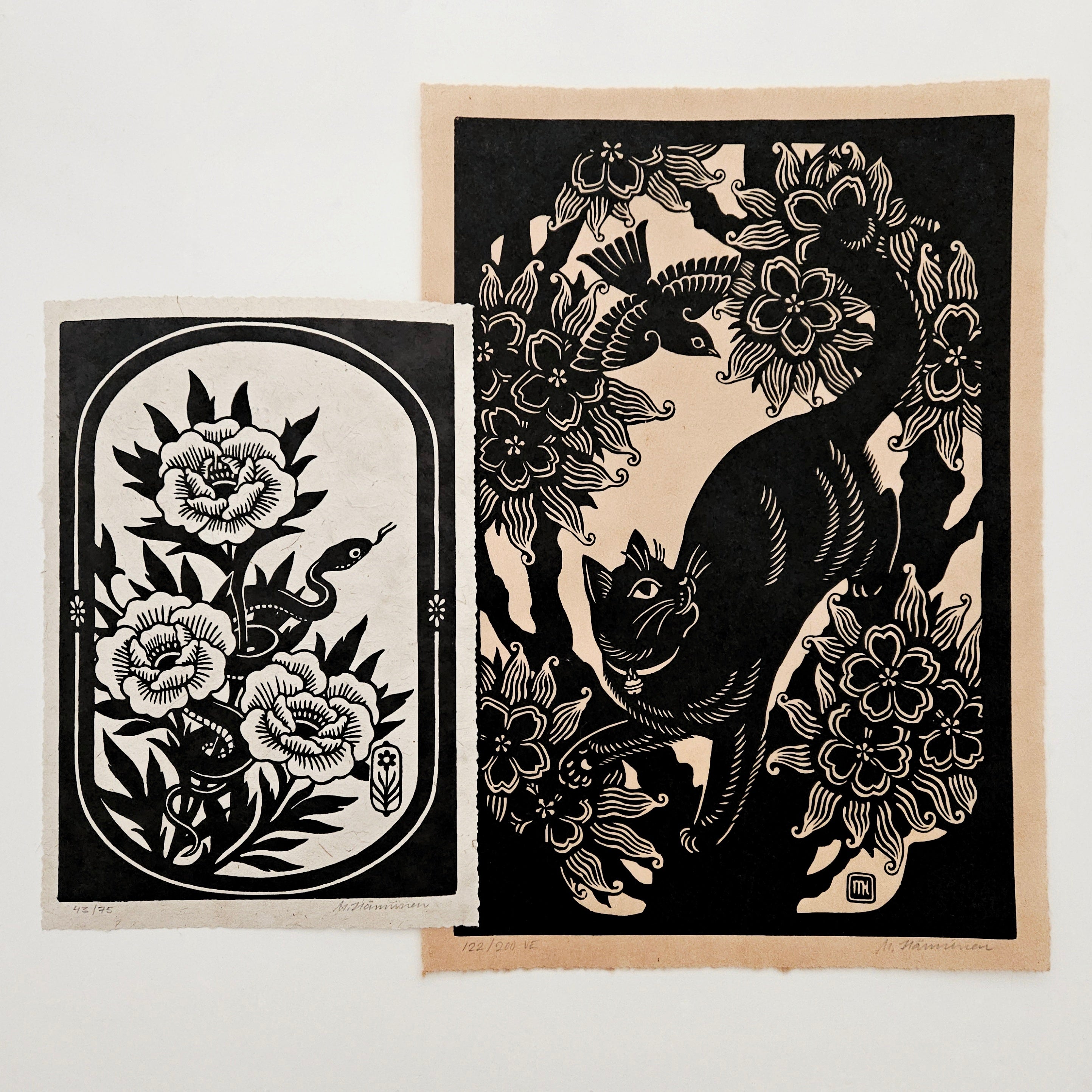 Two linocut prints on a white table