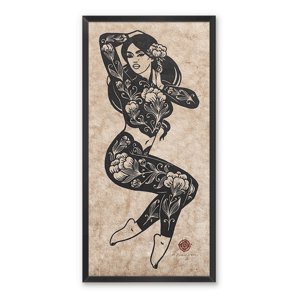A linocut print of a woman adorned in floral patterns, framed on a white wall
