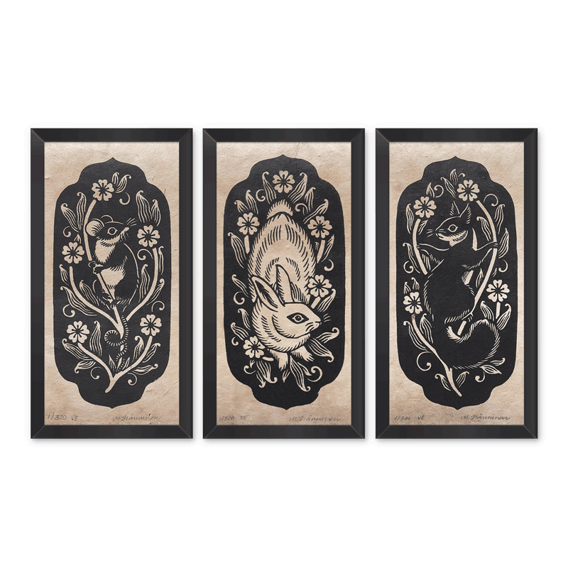 Linocut triptych of mouse, rabbit and squirrel, framed on white wall