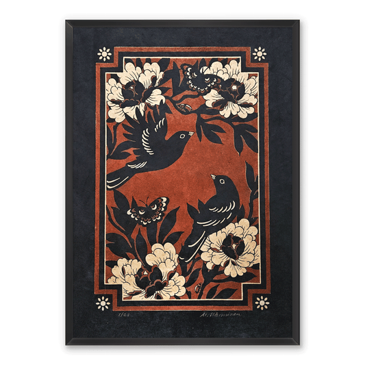 A framed linocut print featuring a folk-art style design with two black birds, gold flowers, and butterflies on a textured red background, enclosed in a dark charcoal frame.