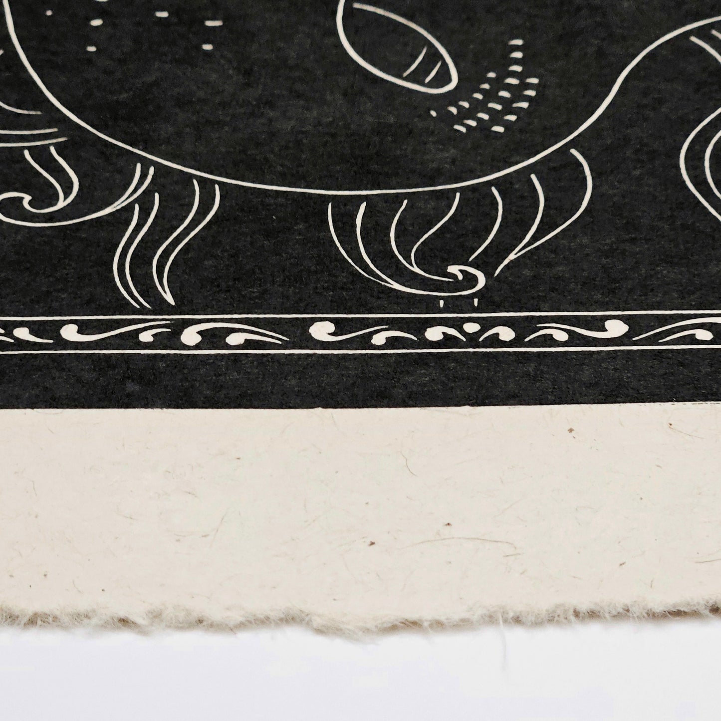 Decorative black and white patterned print on a textured surface
