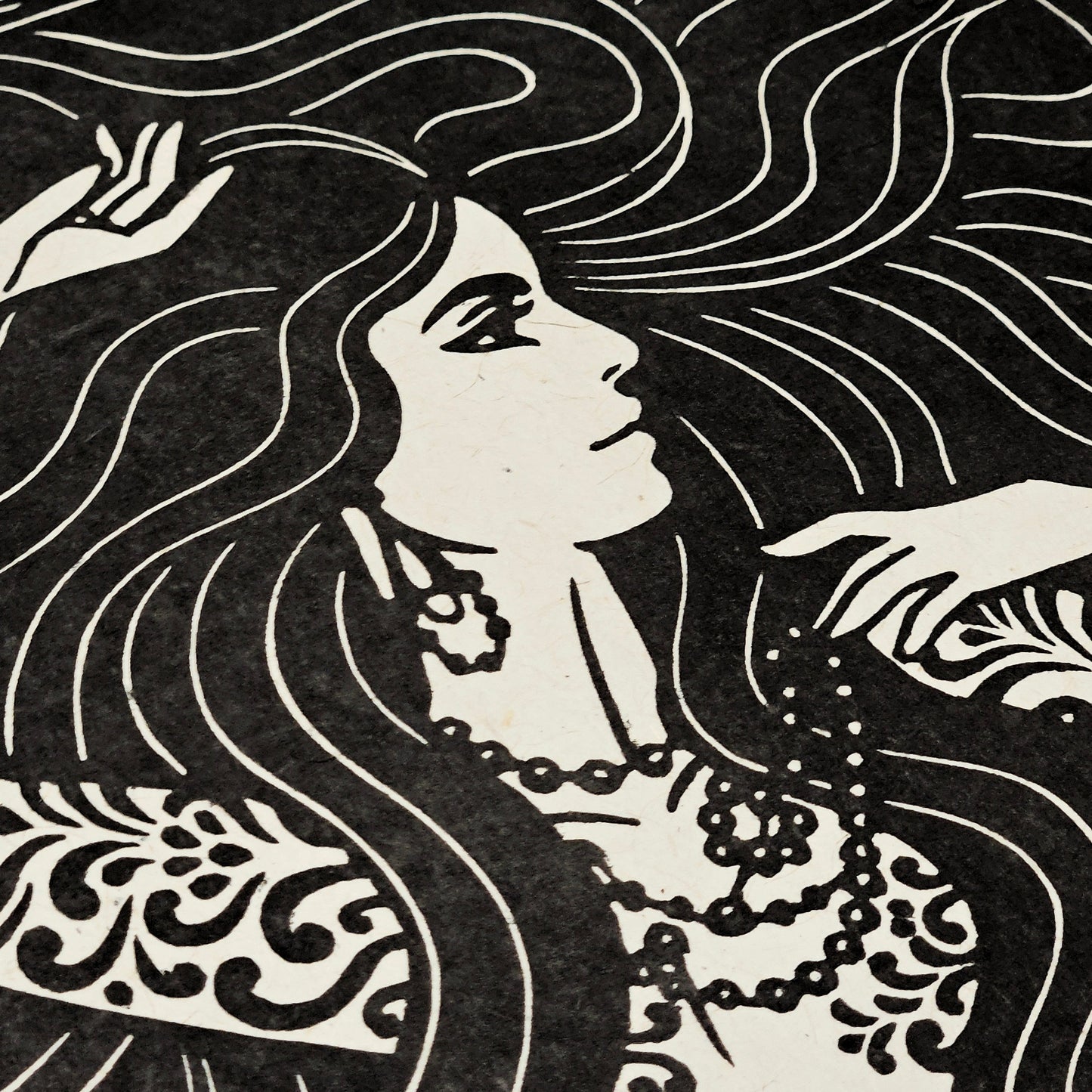 Black and white illustration of a woman with flowing hair and decorative elements.